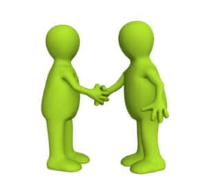 two people shake hands working together for better mental health services