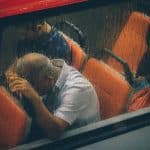 a man has anxiety on a bus on his way to work.