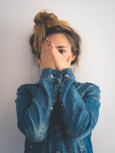 Girl hides her face with no confidence 