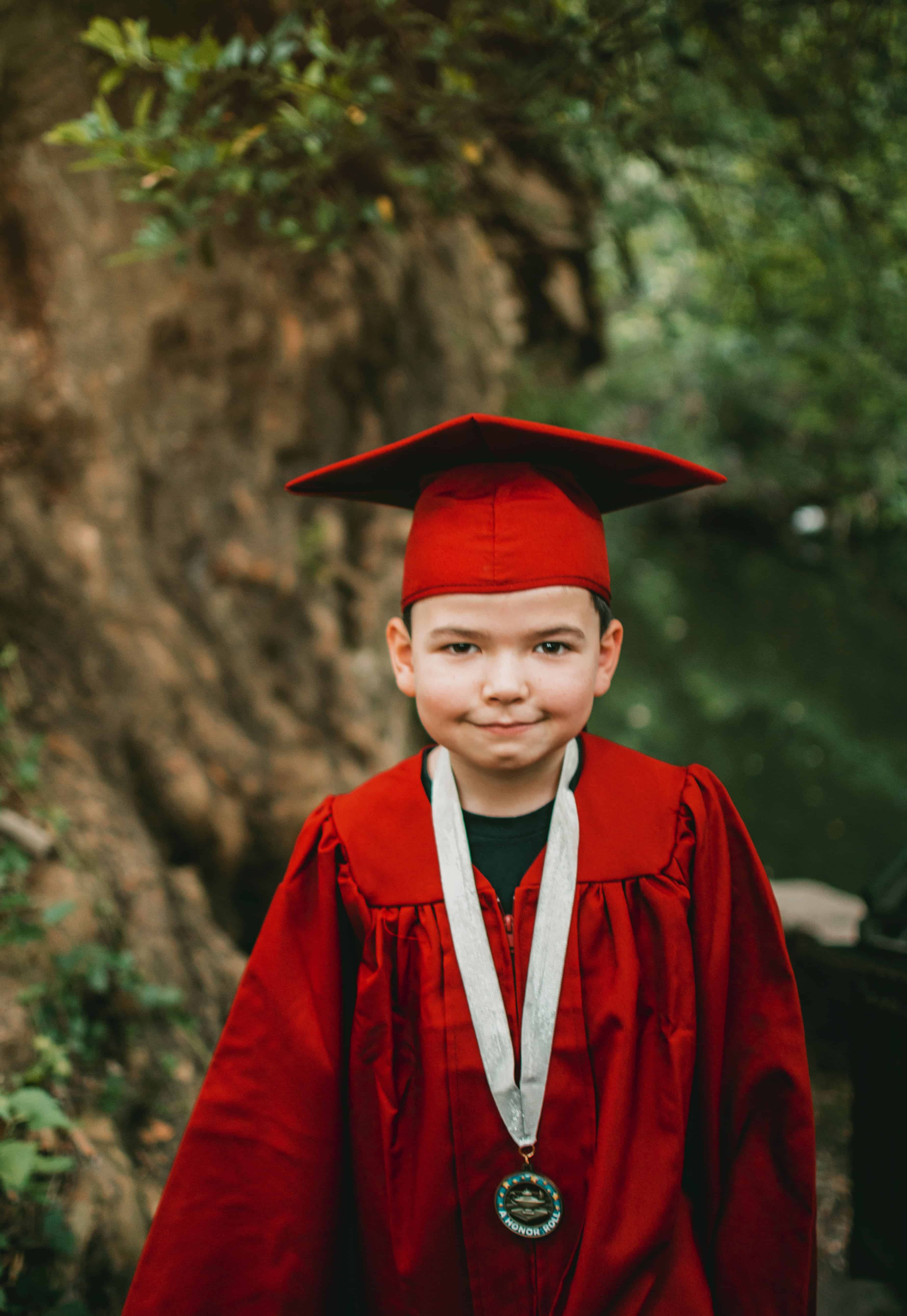 Proud young boy in graduation outfit by Gabriel tovar